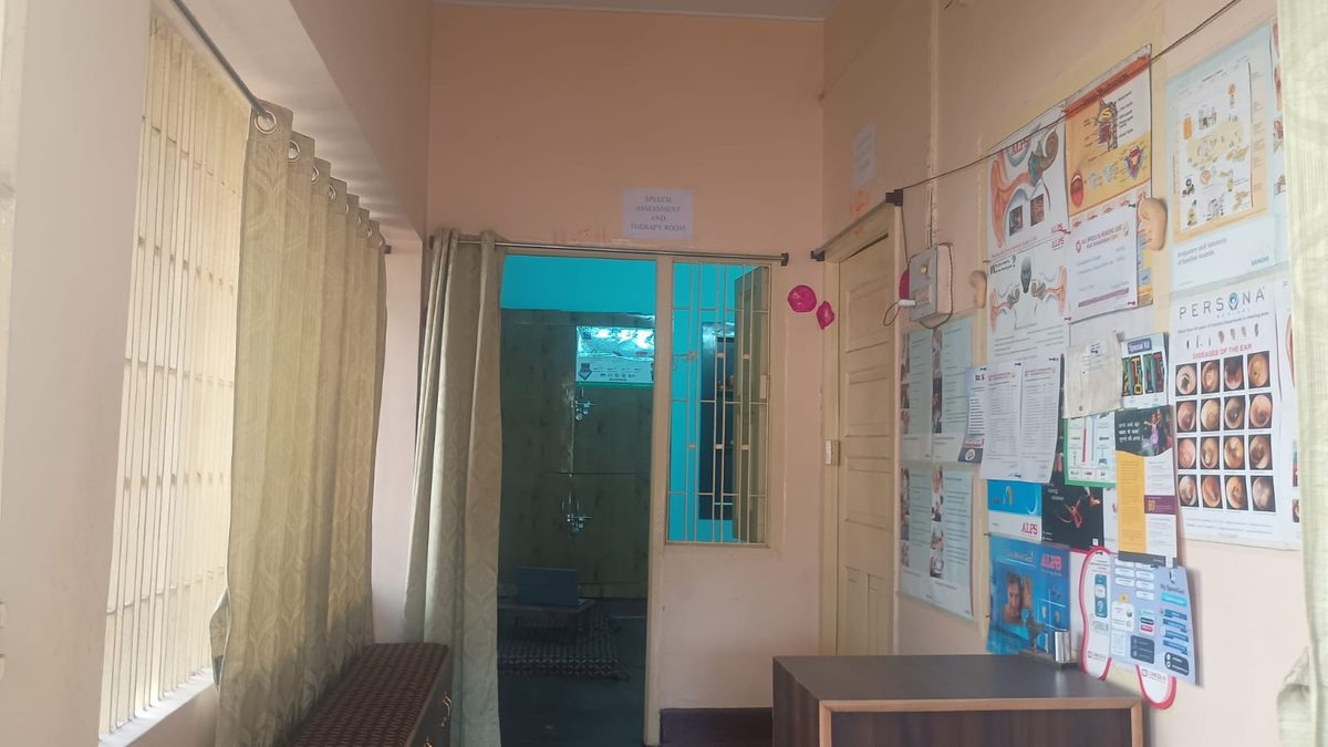 Raj Speech and Hearing Care clinic reception and waiting area with patient health education posters