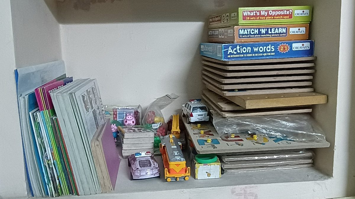 Therapy room shelf with learning materials books and educational toys